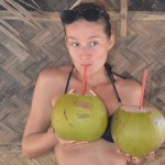 crazy sexy fun traveler drinking coconut water in the Philippines