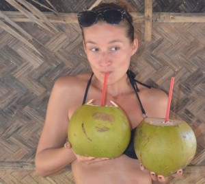 crazy sexy fun traveler drinking coconut water in the Philippines