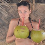 crazy sexy fun traveler drinking coconut water in the Philippines